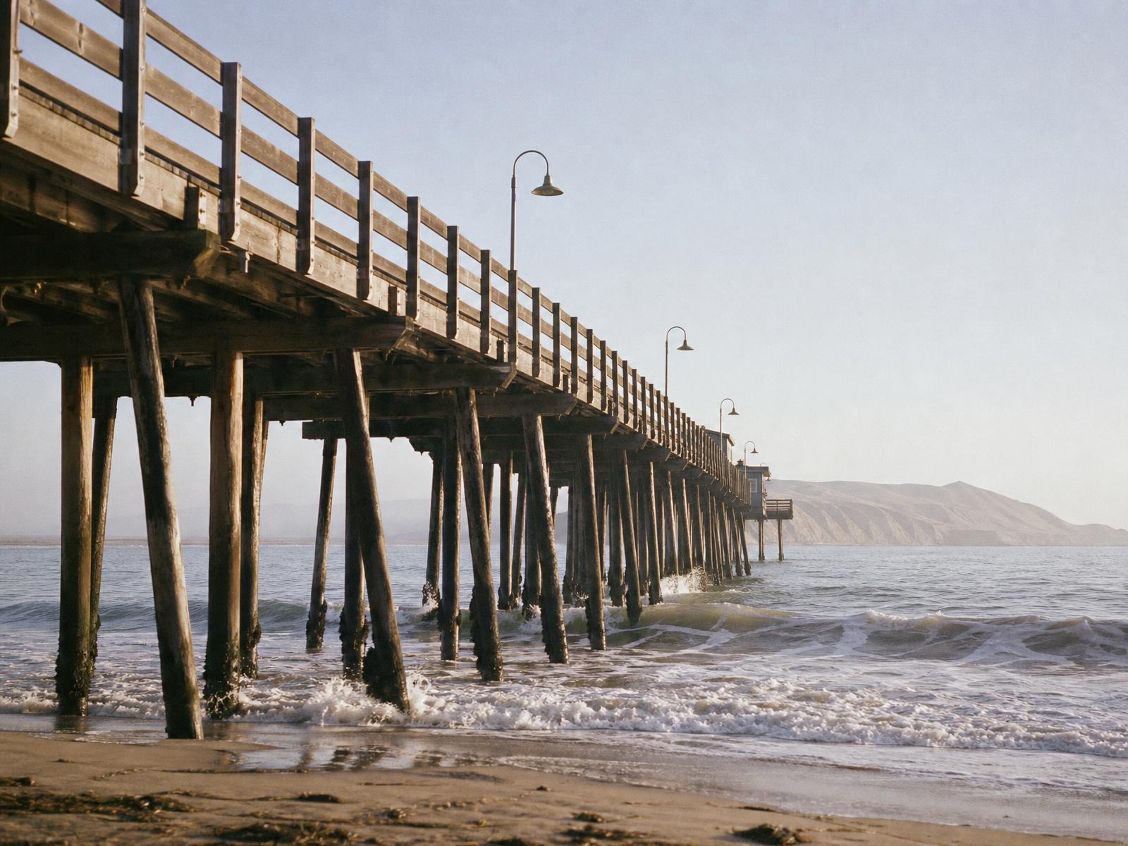 Cayucos Pier stretching over the Pacific on California's Central Coast in late afternoon light